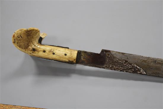 A Turkish sword Yataghan, with silver inlaid decoration and inscription, ivory grips, overall length 72cm